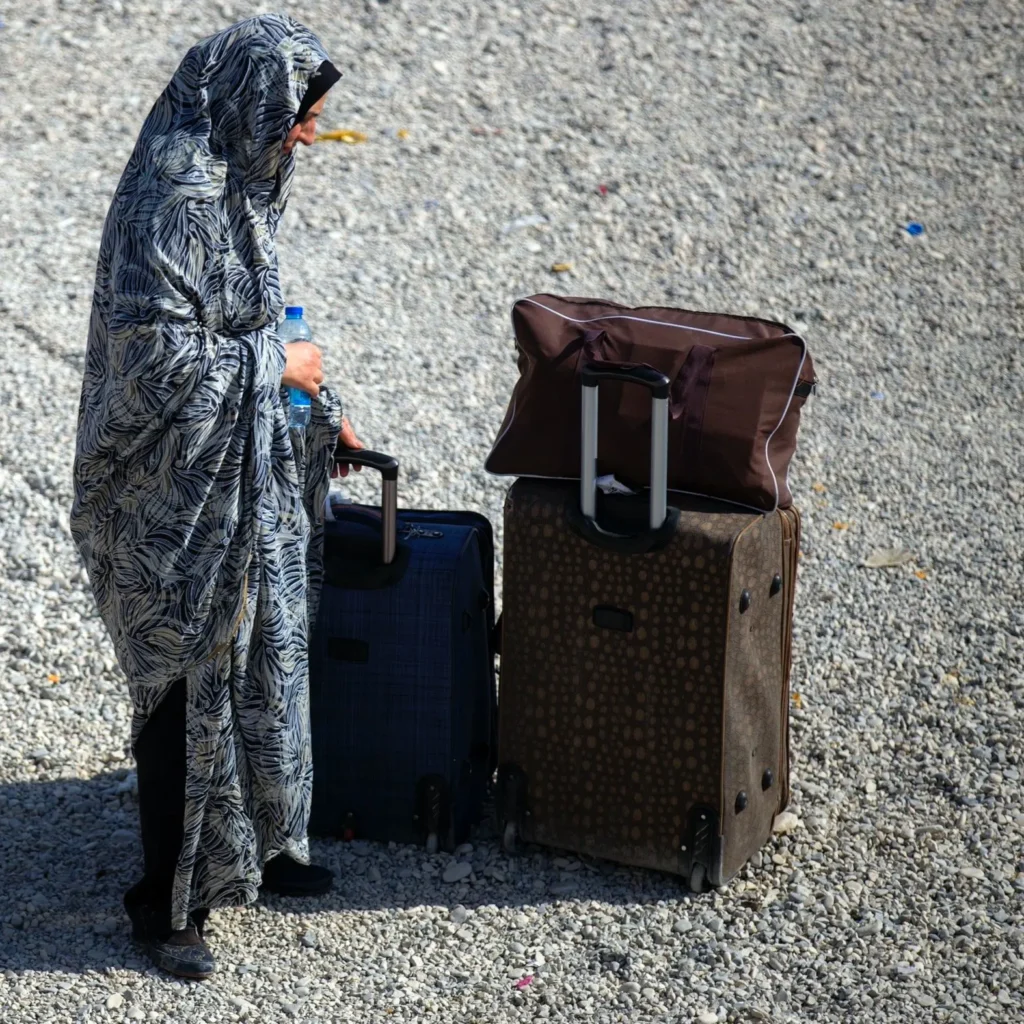 Woman with two suitcases and a bottle of water